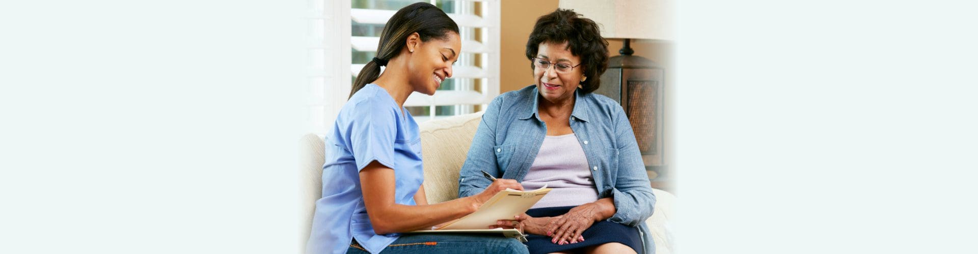 A woman sitting next to an older person.