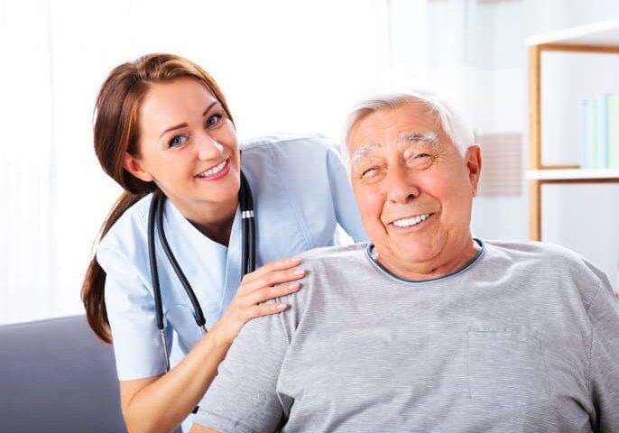 A nurse is standing next to an older man.